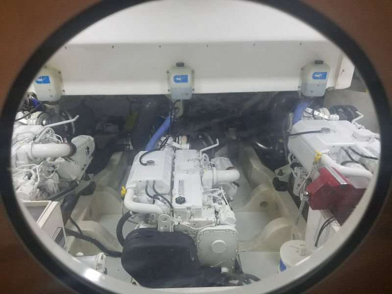 Cummins triple diesel marine engine setup through a porthole window